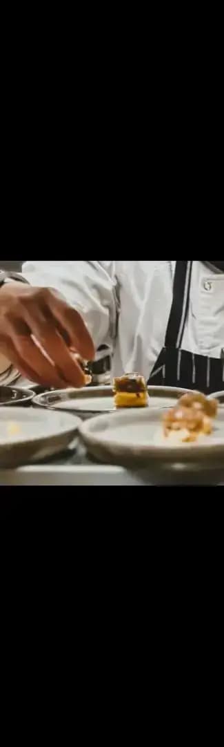 A chef delicately puts the finishing touches to a dessert